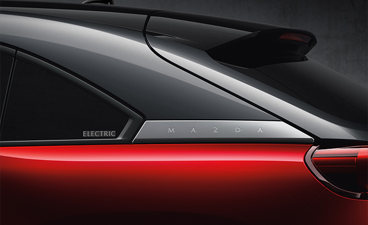 Close-up of back window on driver’s side of red Mazda MX-30.