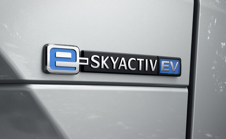 Close-up of SKYACTIV EV emblem on white Mazda.