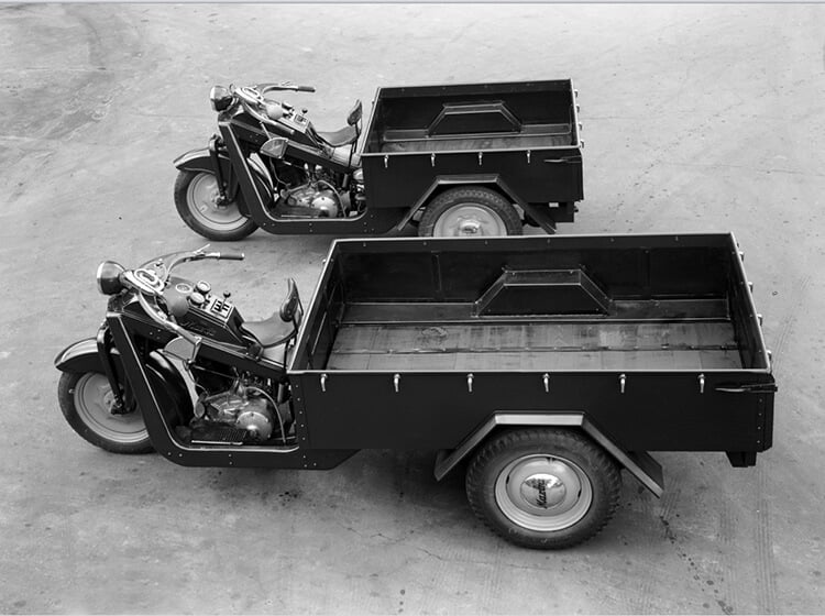 Two Mazda-Go three-wheeled vehicles from three-quarter overhead view
