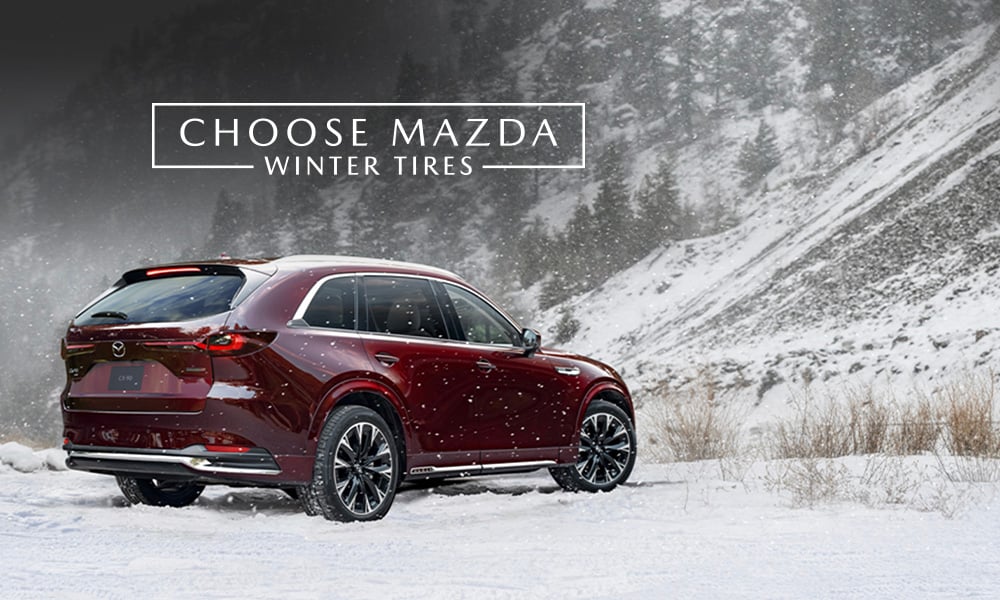 A Mazda CX-90 driving on a snowy road