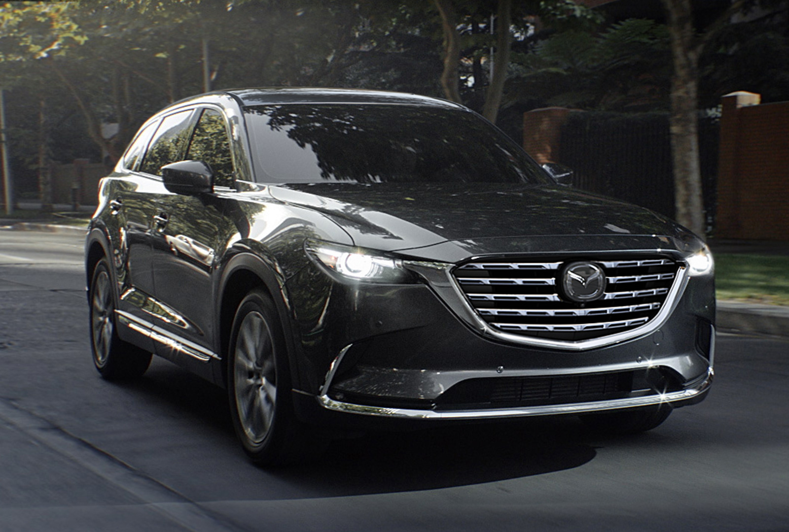 Mazda CX-9 approaches with headlights on