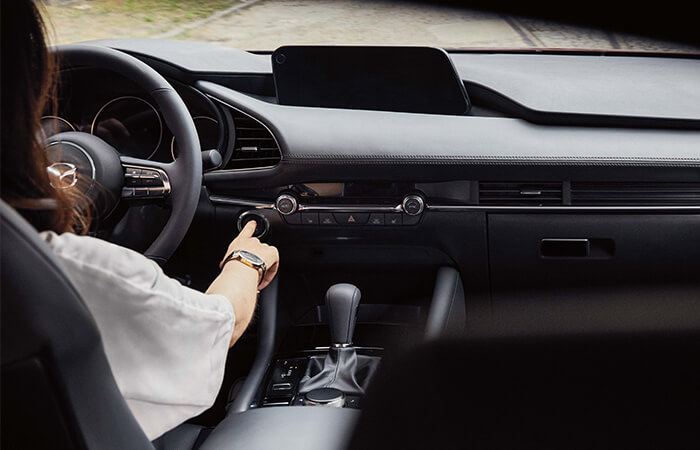 Mazda3 cockpit showing dashboard controls and Mazda Connect display screen.