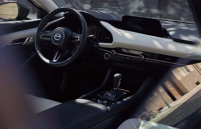 Mazda3 cockpit with steering wheel.