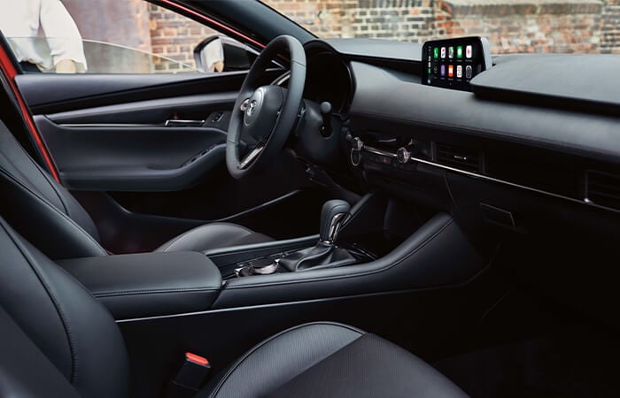 Mazda3 Sport cockpit clad in black leather upholstery.