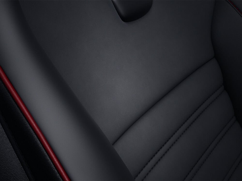 “Detail of Recaro® fabric showing Nappa leather with Alcantara® piping.”