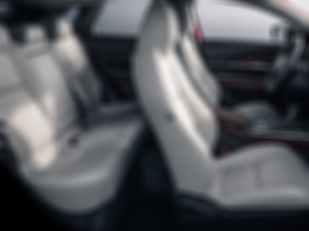 Unobstructed view of the front and back seats inside the CX-30 with White Nappa leather seating.  