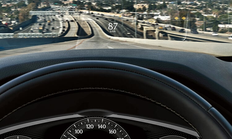 Driver’s view, 87 km/h is projected onto the CX-90's interior windshield. 