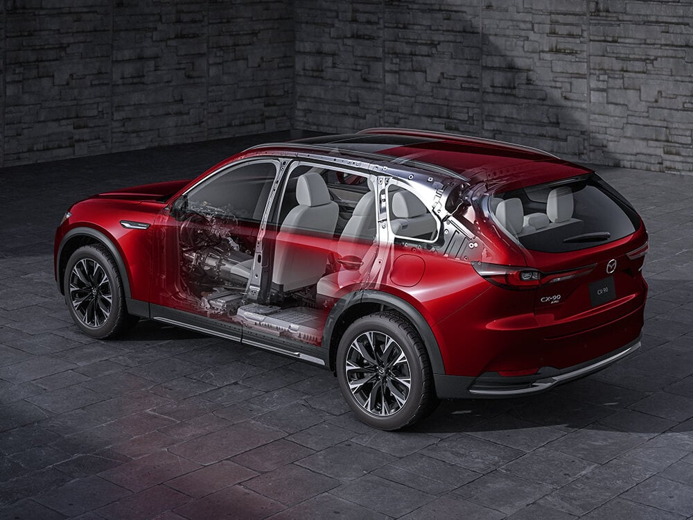 X-ray, see through view of an Artisan Red CX-90 revealing vehicle components in front of the wheel and below the floor.
