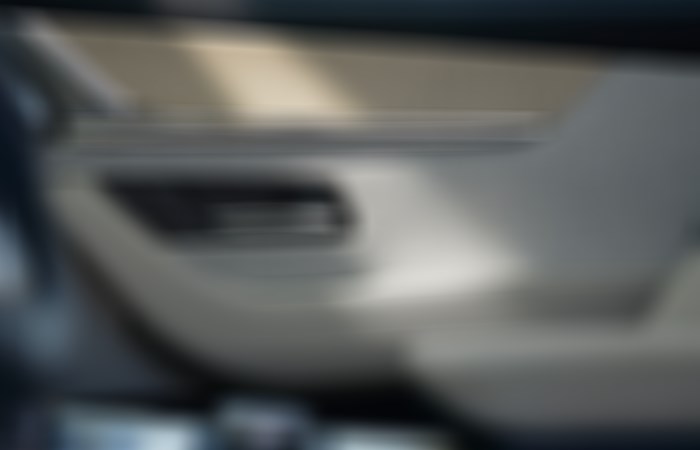 Closeup of different materials featured on the interior door panel of the CX-90.  