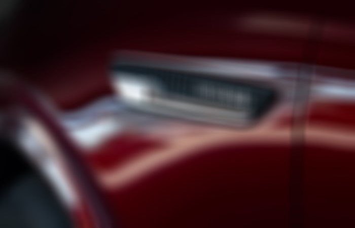 Closeup of inset Inline 6 decal on Artisan Red CX-90.