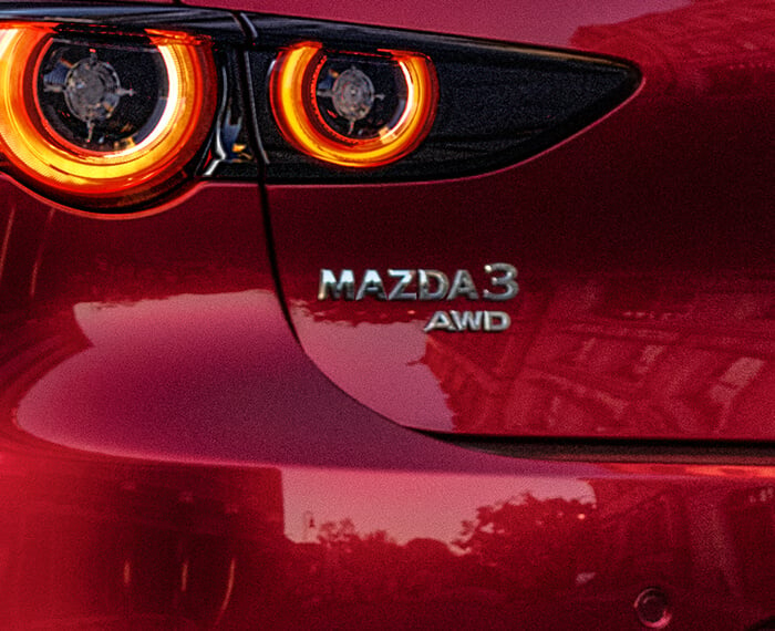 Closeup of Mazda3 AWD badge. 