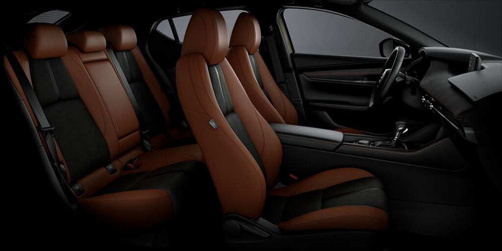 Unobstructed view of the entire Mazda3 Sport Terracotta/Black Leatherette interior from the passenger’s side.