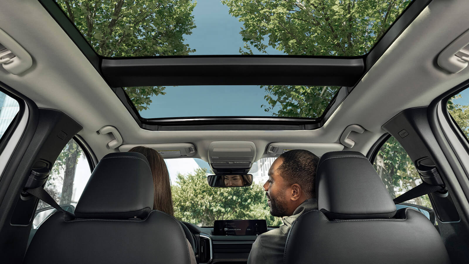 Looking up through open Panoramic Moonroof from 2nd row seats.