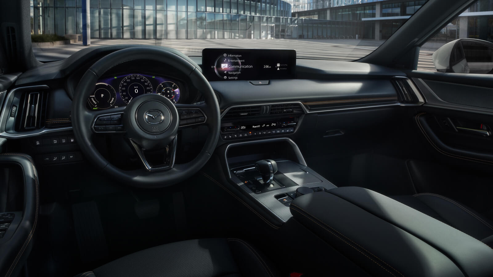 Driver’s seat view of the CX-90 Plug-In Hybrid’s interior and dash. 