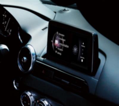 Interior view of the MX-5 ST dashboard with the touchscreen interface displaying a variety of apps.